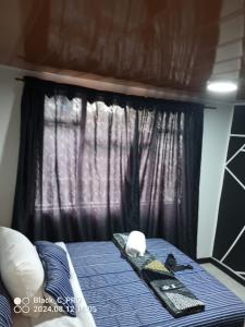 a bed in a room with a window at Sweet Bed in Bogotá