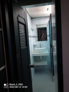 a bathroom with a sink and a mirror at Sweet Bed in Bogotá