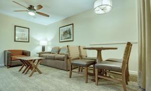 a living room with a couch and a table and chairs at Beautiful Hotel in Durango 1BD in Durango
