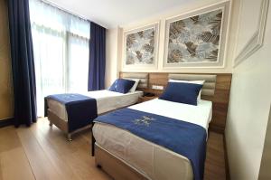 a hotel room with two beds and a window at New Fors Hotel in Istanbul +22 photos