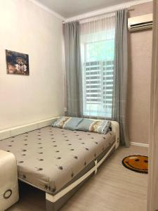 a bedroom with a bed and a window at Elisavetinskaya 15 in Odesa +11 photos