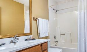 a bathroom with a sink and a toilet and a mirror at Beautiful Hotel in Pagosa 2BD in Pagosa Springs +4 photos