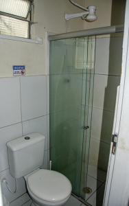 a bathroom with a toilet and a glass shower at Studio 51 residence in Recife +42 photos