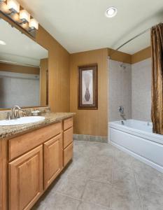a bathroom with a tub and a sink and a bath tub at Worldmark Seaside Condo 2BD in Seaside
