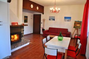 a living room with a table and a fireplace at Tana Degli Orsi in Cantalupo Ligure