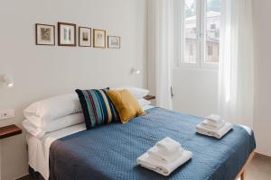 a bedroom with a bed with two towels on it at Senape - Menaggio by LoveComo in Menaggio