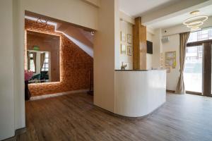 an office with a brick wall and a reception counter at Pensiunea Natalya in Bacău