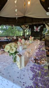 a long table with flowers and butterflies on it at GA Grudzianka in Lwówek