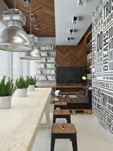 a lobby with a table and benches and a couch at ICON Hostel in Moscow