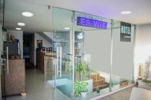 a glass wall in a lobby with plants in it at Hotel Los Angeles in Calarcá