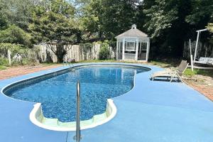 a swimming pool with a gazebo in a yard at Indian Lakes in Stone Mountain