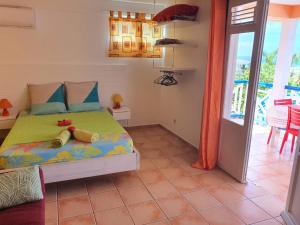 a bedroom with a bed with two stuffed animals on it at La Villa Océane in Le Moule +18 photos