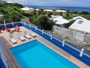 a swimming pool with a view of the ocean at La Villa Océane in Le Moule