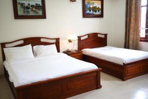 Postel nebo postele na pokoji v ubytování Hùng Phong Hotel - Near Dalat Market