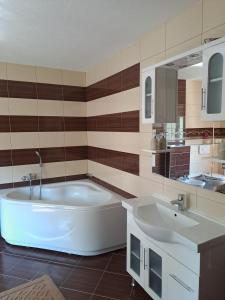 a large bathroom with a tub and a sink at Vila Jasmina in Bihać +55 photos