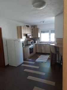 a kitchen with a white refrigerator and a sink at Vila Jasmina in Bihać