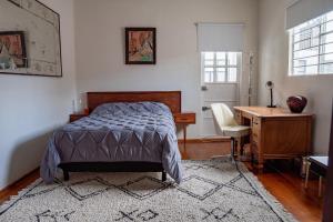 a bedroom with a bed and a desk and a desk at Uotan in Mexico City +68 photos