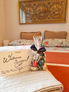 ein Schild mit einer Schachtel darauf auf einem Bett in der Unterkunft Incantevole ed elegante appartamento a Niguarda! in Mailand