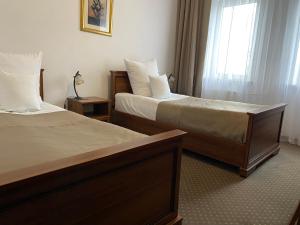 Łóżko lub łóżka w pokoju w obiekcie Hotel Constancja