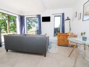 a living room with a couch and a table at Priestleys Retreat in Blackburn