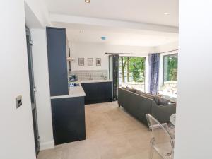 a living room with a couch and a kitchen at Priestleys Retreat in Blackburn +18 photos