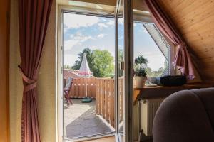 a sliding glass door with a view of a balcony at Ferienwohnungen Engelmann, 35107 in Holtland