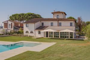 a large house with a swimming pool in the yard at Tenuta Asmara Luxury Resort in San Miniato