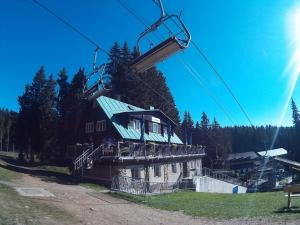 a ski lift with a house on it at Ski & Bike Špičák in Železná Ruda +24 photos