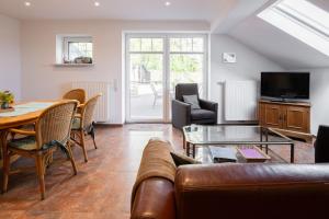 a living room with a couch and a table at Ferienwohnung Birken Allee, 35181 in Schwerinsdorf