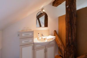 a bathroom with a sink and a mirror at Ferienwohnung Birken Allee, 35181 in Schwerinsdorf +41 photos