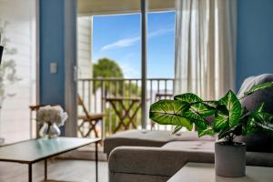 a living room with a couch and a table at Serenity on the Sea Luxury Condo with Private Balcony on the Ocean in Tampa