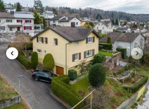 a house with a car parked in front of it at schönes Haus 5 separates Zimmer mit Sauna in Bonstetten