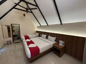 a bedroom with a large bed in a room at 100 Oaks Estate in Yercaud