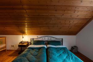 a bedroom with a bed and a wooden ceiling at Ferienwohnung Pop s Huus 35226 in Holtland