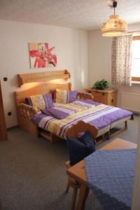 a bedroom with a large bed and a table at Stoanock Diamant in Bad Kleinkirchheim