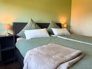 two beds sitting next to each other in a room at Ferienwohnung Wolf in Roth