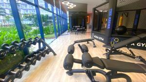 a gym with a row of exercise equipment on the floor at SUNNY SMES - Airport & Downtown in Dien Khanh +36 photos