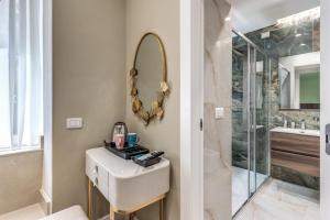 a bathroom with a sink and a mirror at Le stanze di Venere in Naples