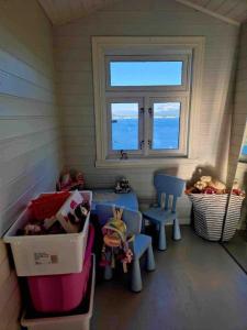 a room with two chairs and a table and a window at Kræmarvika Vila in Tromsø +8 photos