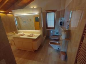 a bathroom with a sink and a toilet and a mirror at schönes Haus 5 separates Zimmer mit Sauna in Bonstetten +20 photos