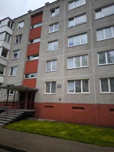 an apartment building with a staircase in front of it at Debreceno apartamentai in Klaipėda