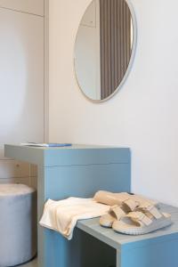 a counter with a mirror and a table with towels at Acquamarina Apartment in Rivabella +37 photos
