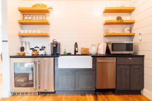 a kitchen with black cabinets and a counter top at The Franklin Hotel Martha's Vineyard in Edgartown