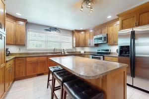 a large kitchen with wooden cabinets and a large island at Lake Time Retreat in Dandridge