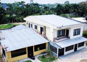 an overhead view of a white building with a roof at Casa Oasis in Leticia