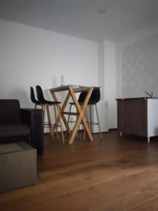 ヴルシャツにあるSandra apartmani 4の木製のテーブルと椅子のあるリビングルーム