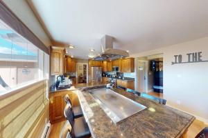 a kitchen with a large island in the middle at Tacit Shadow Resort Aviator Queen Suite, Gym, Coffee Bar, Hot-Tub, Free Laundry, Food Available in Parowan