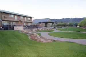 a yard with a building and a patio at Tacit Shadow Resort Aviator Queen Suite, Gym, Coffee Bar, Hot-Tub, Free Laundry, Food Available in Parowan