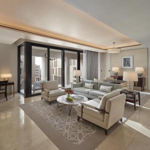 a living room with a couch and chairs and a table at Mandarin Oriental, Doha in Doha