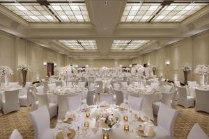a banquet hall with white tables and white chairs at Mandarin Oriental, Doha in Doha +37 photos